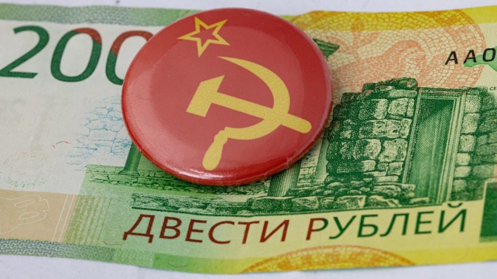 a red button with a hammer and a star on it